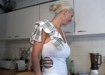 A Blonde With Glasses On Her Knees Nursing On A Dick