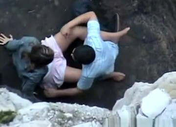 Lovers On Rocky Beach