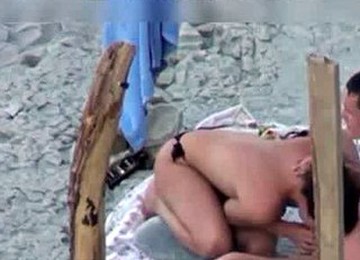 A Couple Is Spying On Camera At The Beach